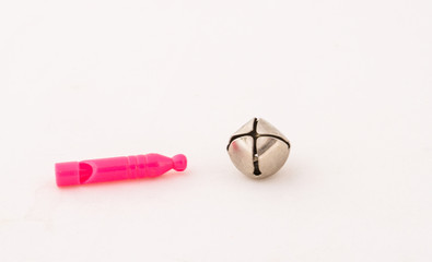 Whistles and a silver bell isolated on a white background image in landscape format with copy space