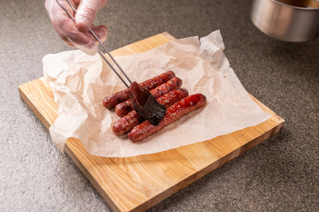 Food and delicious concept - Horse meat sausage covered with ketchup