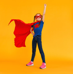 concept of child superhero costume on yellow background.