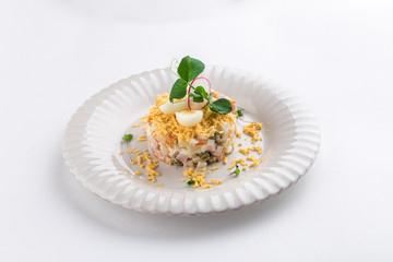 Russian traditional salad Olivier with egg isolated on white background