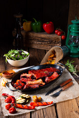 Grilled ribs in spicy marinade with salad and vegetables