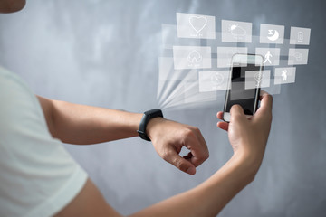 A Sport man is using smart band with virtual screen device