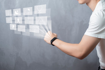 A Sport man is using smart band with virtual screen device