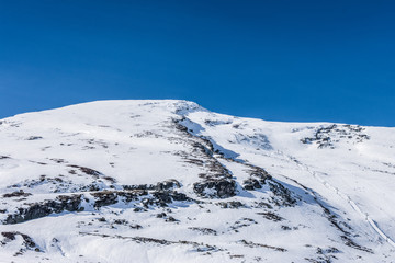 Fototapeta na wymiar snowy mountains with blue sky