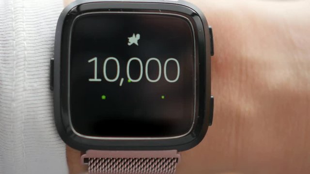 10,000 steps goal on smartwatch, fitness tracker, fireworks, motivation