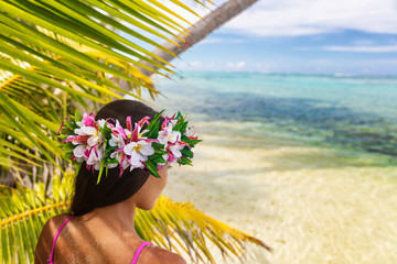 Hawaii beach woman luau dancer relaxing wearing wreath of fresh flowers on Tahiti Bora Bora, French Polynesia. - obrazy, fototapety, plakaty