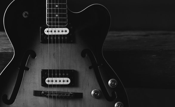 semi-hollow body guitar on black background