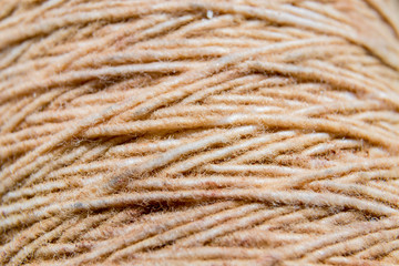 Thread in clew close up picture. Close up of light burlap texture background. Twine. Top view. Copy space.