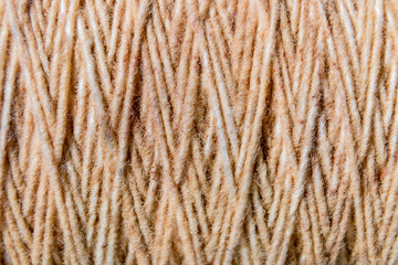 Thread in clew close up picture. Close up of light burlap texture background. Twine. Top view. Copy space.