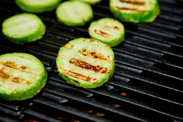 Grilled zucchini vegetable on huge gas grill . Vegan food. Diet, healthy Picnic. Summer. Top view. Flat lay. Copy space..
