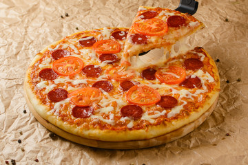 Hot pizza on craft paper background