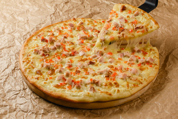 Hot pizza on craft paper background