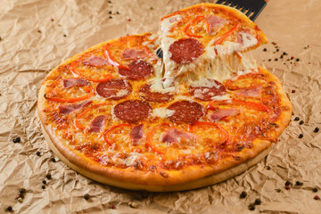 Hot pizza on craft paper background