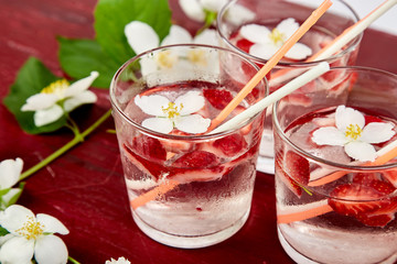 Strawberry detox water with jasmine flower. Summer iced drink