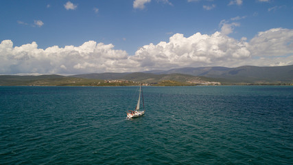 Aerial view of sailboat at sea in Turkey. Aerial view of beautiful green lagoon at hot summer day
