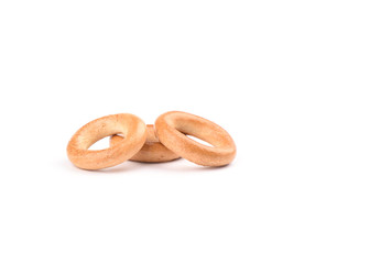 Three crispy bagels isolated on white background.