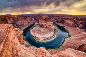 Horseshoe Bend on Colorado River at Sunset with Dramatic Cloudy Sky, Utah