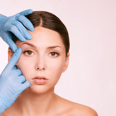 Female derma rejuvenate treatment. Doctor in gloves touch woman face. Cosmetology pretty portrait. Facial injection patient