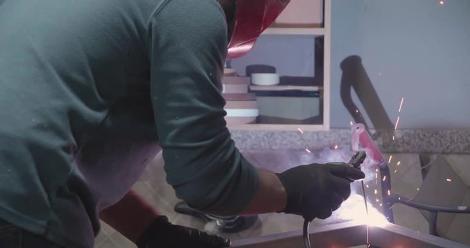 A Man With A Mask Welding