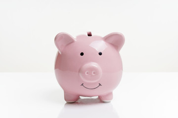 piggy or coin bank or piggybank or money box - finance and savings concept on white background with reflection