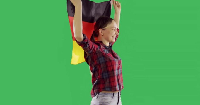 Happy adult woman run with the German flag on chroma key green screen.