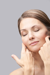 Natural beauty portrait with hands. Cosmetology mature woman face. Cosmetic cream. Skin care....