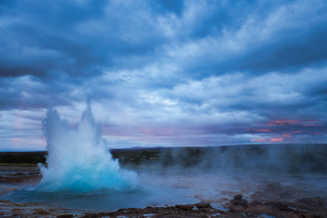 Strokkur Geysir Eruption with Dark Cloudy Sky, Iceland