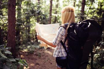 Hipster tourist woman with map hiking, lifestyle adventure concept