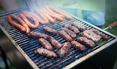 Delicious assorted grilled meat with vegetables over the coals on barbecue