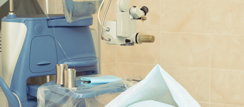 Ophthalmology laser microscope operation. Clinic room with doctor and parient. Gloves and medicine tools