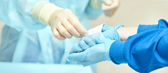 Ophthalmology laser microscope operation. Clinic room with doctor and parient. Gloves and medicine...