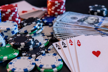 Dollar banknotes with four aces and colorful poker chips