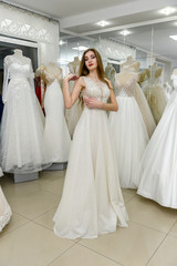 Naklejka premium Full length photo of bride in wedding shop