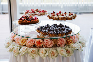 Cupcakes decorated with strawberries served on a banquet table.