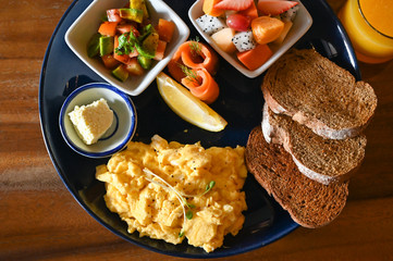Big breakfast with eggs, fruit and bread