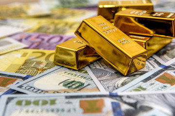 Paper money and gold ingot, close up