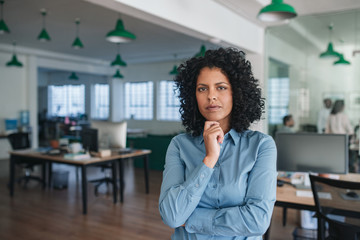 Young businesswoman standing confidently in a modern office