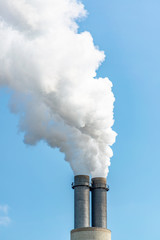 Großer Industrie Schornstein stößt Rauch aus.