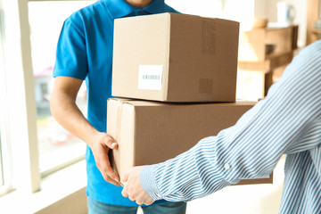 Woman receiving boxes from delivery man
