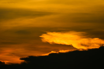 multicolor heap giant orange sunset cloud and dark sky