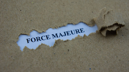 Torn paper with text force majeure