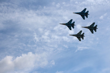 Fototapeta na wymiar Four aircraft combat fighters SU-34 military fighters flying in the sky a great strong powerful