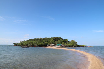 Scenery of beautiful seascape and golden dragon beach and fishery village with blue sky background.
