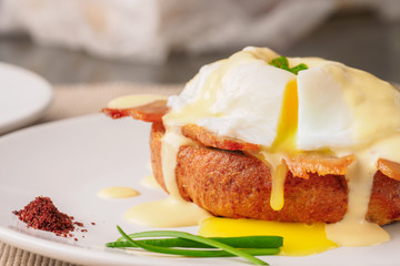 Breakfast is Eggs Benedict - toasted English muffins, bacon, ham, poached eggs, herbs and delicious buttery hollandaise sauce.