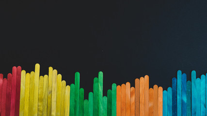 Colorful sticks isolated on black background