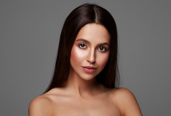 Naklejka premium Beautiful woman with long hair and big brown eyes isolated on gray background