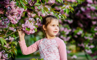 blossom smell, allergy. small girl child in spring flower bloom. happy girl in cherry flower. Sakura tree blooming. skincare spa. Natural cosmetics for skin. summer. Forever young and free