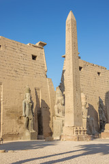 The entrance of the Temple of Luxor with an obelisk and statues of Ramesses II