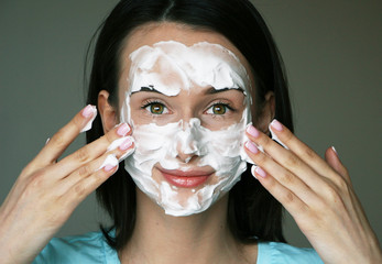 white cleansing mask on the girl's face