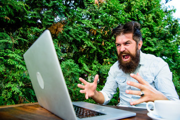 Hipster busy with freelance. Wifi and laptop. Slow internet irritating. Drink coffee and work...